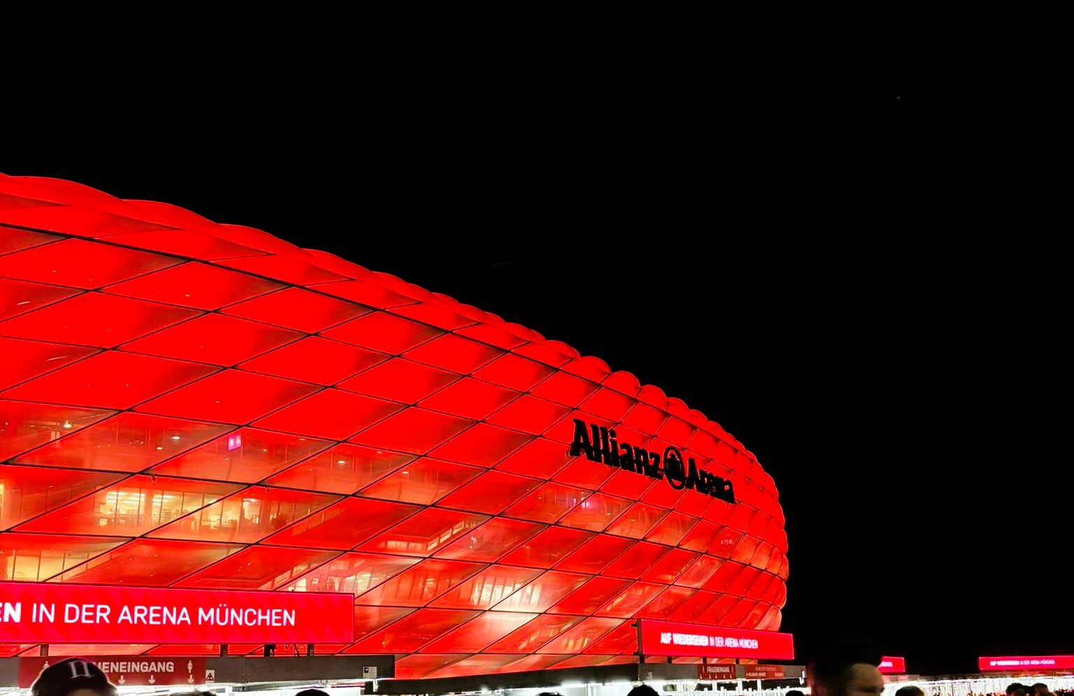 Allianz Arena illuminated in red at night in Munich, Germany.