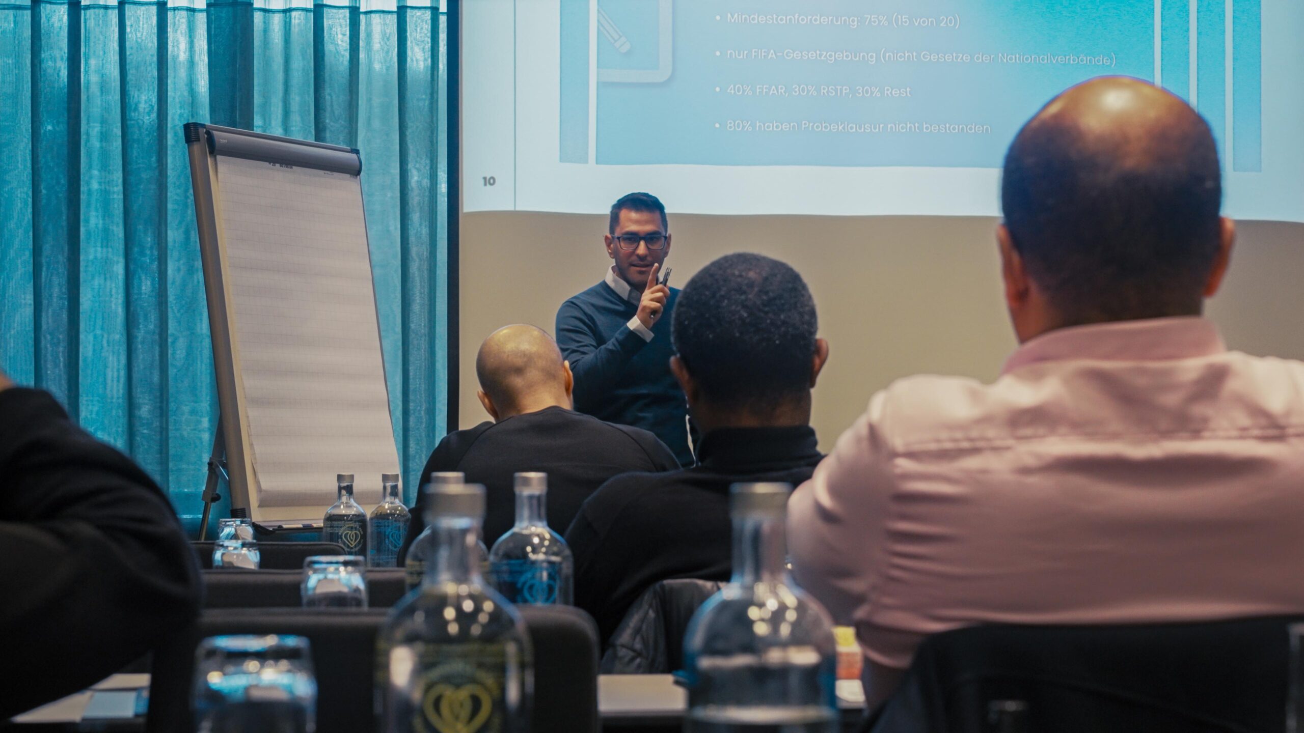 Dr. Erkut Sogut teaching aspiring football agents during a live classroom session