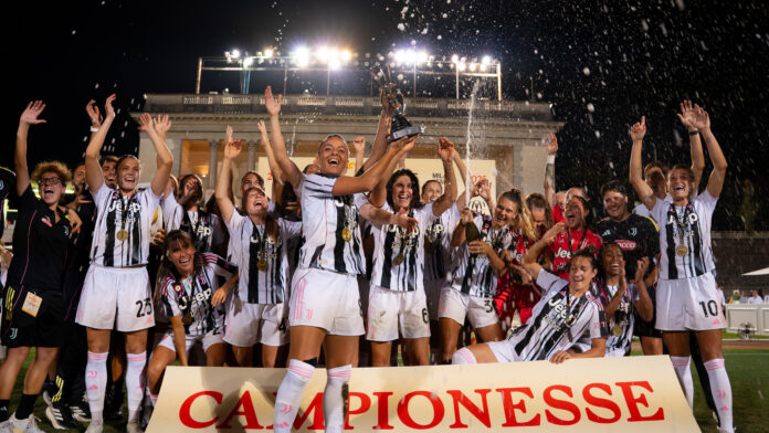 Juventus Women celebrate winning The Women’s Cup Milan 2025, lifting the trophy with gold medals and champagne under stadium lights