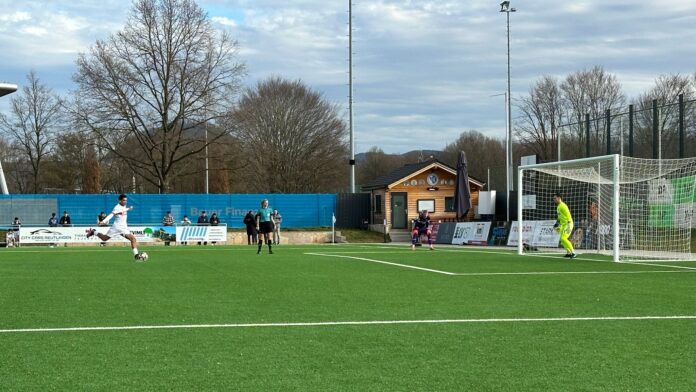 Youth footballer from VfB Stuttgart U19 takes a penalty shot during a competitive match, symbolizing key career moments where guidance matters.