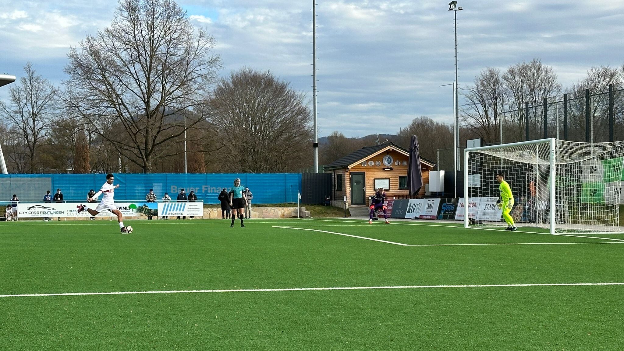 Youth footballer from VfB Stuttgart U19 takes a penalty shot during a competitive match, symbolizing key career moments where guidance matters.