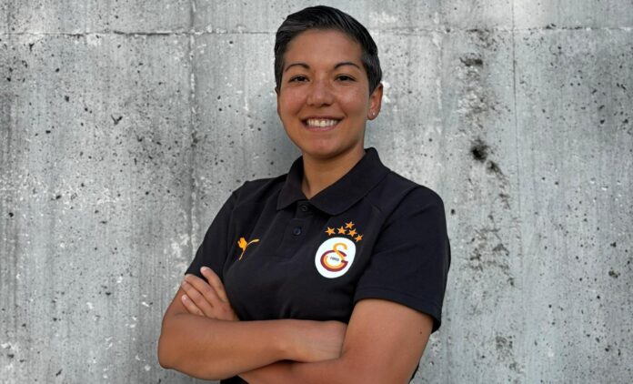 Çağla Korkmaz, Assistant Coach and Head of Girls Academy at Galatasaray, posing confidently in a Galatasaray polo shirt.