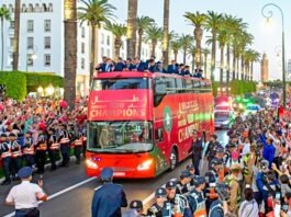 Morocco U20 national team celebrating their FIFA U20 World Cup victory with fans during the open-top bus parade in Rabat.