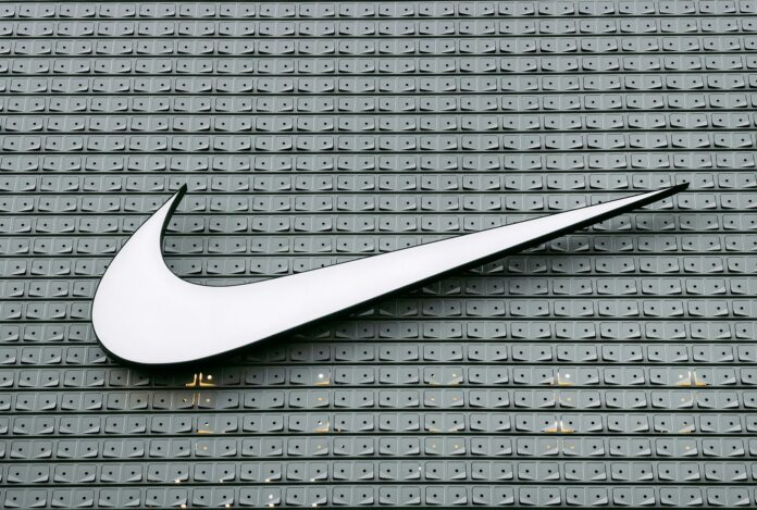 The Nike swoosh logo on a patterned wall, symbolising one of the most iconic sports marketing brands in the world.