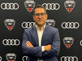 Who is Dr. Erkut Sogut? Dr. Erkut Sogut, Managing Director of Soccer Operations at D.C. United, stands in front of the club’s logo backdrop.
