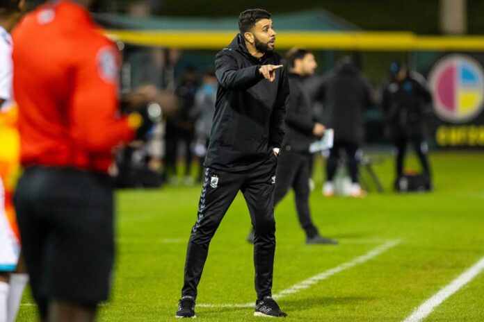 Jeyhan Bhindi directing his team from the touchline during a USL League One match