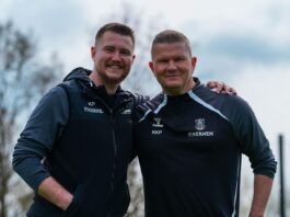 Kenneth Kretschmer Petersen standing with a colleague during a training session, highlighting his role in football recruitment and development.