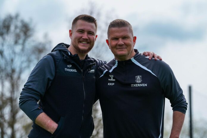 Kenneth Kretschmer Petersen standing with a colleague during a training session, highlighting his role in football recruitment and development.