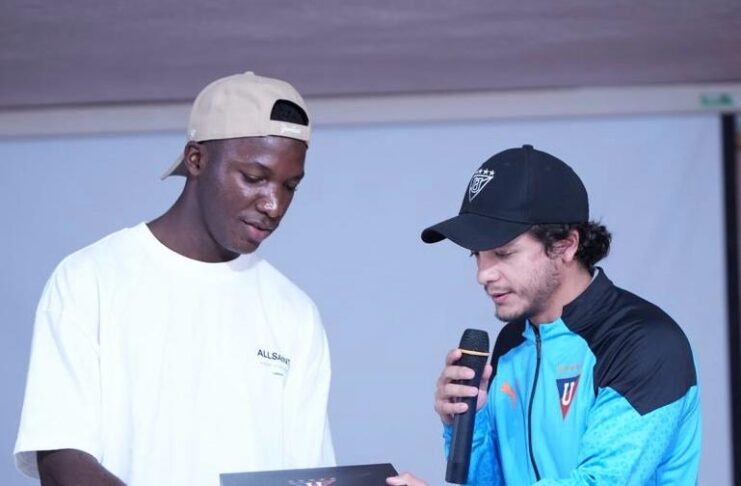 Marco Durán Montenegro presenting a gift to a young player during a club event focused on development and performance culture.