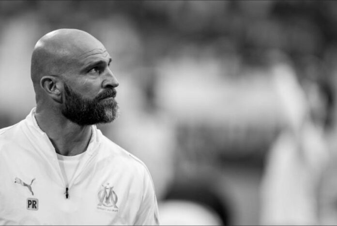 Paolo Rongoni observing the pitch with focus during his role as a top performance coach.