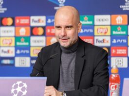 Pep Guardiola speaking at a Champions League press conference, reflecting Spain’s influence on global football coaching.