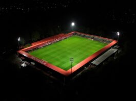 Value Without Victory: What Defines a Football Club Aerial night view of The Peninsula Stadium in Salford, symbolizing the connection between football, business, and community value.