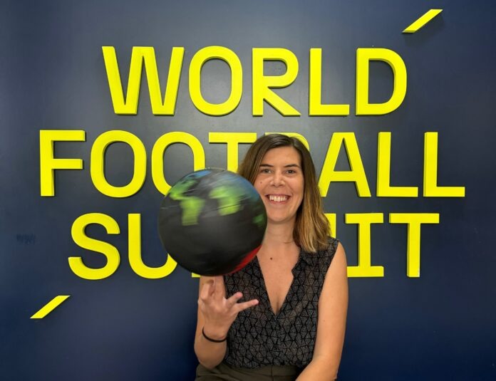 Arantxa Mandiola Arantxa Mandiola smiling in front of the World Football Summit backdrop while spinning a globe-themed football.
