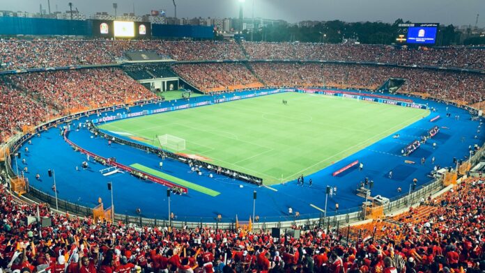 Full stadium view during an AFCON match at Cairo International Stadium, showcasing Egypt's football passion.