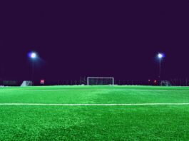 Al Ettifaq and the Rise of Saudi Talent Development Brightly lit football pitch at night with empty goals and training equipment, creating a focused and modern development atmosphere.
