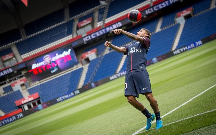 Footballer under media attention during a club presentation, highlighting visibility and reputational risk in brand partnerships.
