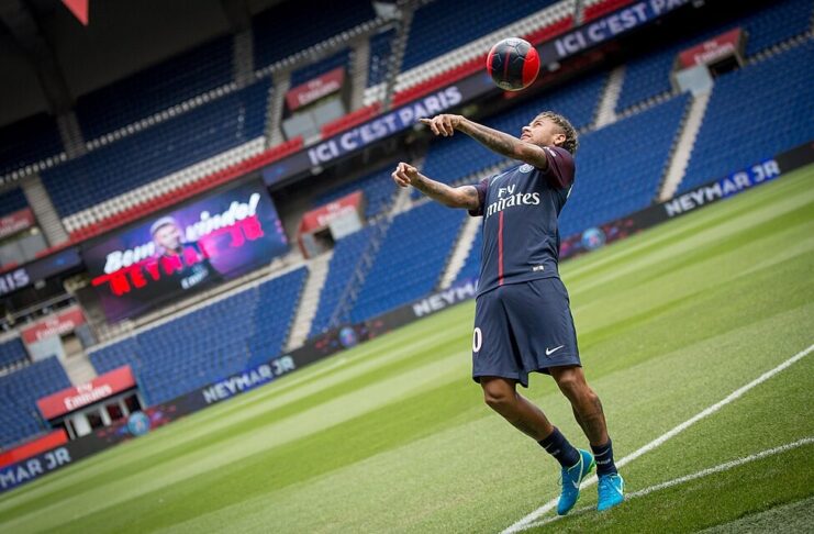 Footballer under media attention during a club presentation, highlighting visibility and reputational risk in brand partnerships.