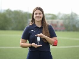 Who is Catarina Martins? Catarina Martins holding a recognition award on a football pitch, reflecting her role in women’s football operations and development.