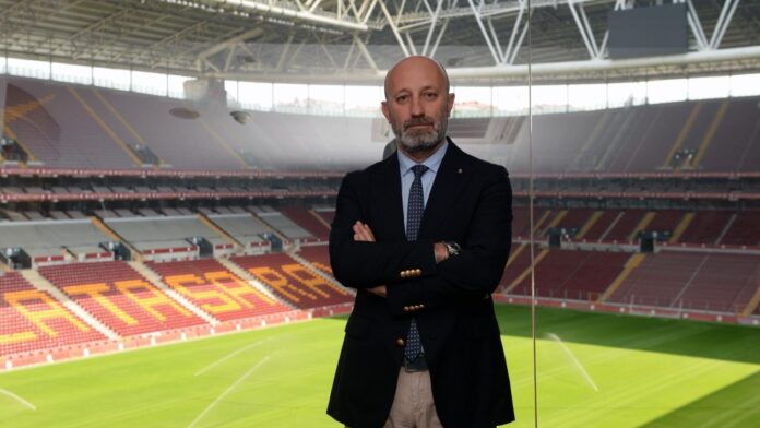 Cenk Ergün standing inside a football stadium, reflecting his role as a senior executive in elite club management.