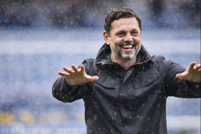 Erol Bulut gestures from the touchline during a match, reflecting his calm leadership and tactical focus as a head coach.