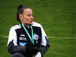Who is Gamze Tutaker? Gamze Tutaker working pitchside during a women’s football match, capturing moments from the technical area.
