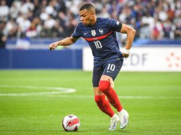 Kylian Mbappé in action for France during an ongoing legal dispute with PSG over unpaid wages.