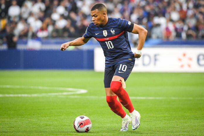 Kylian Mbappé in action for France during an ongoing legal dispute with PSG over unpaid wages.