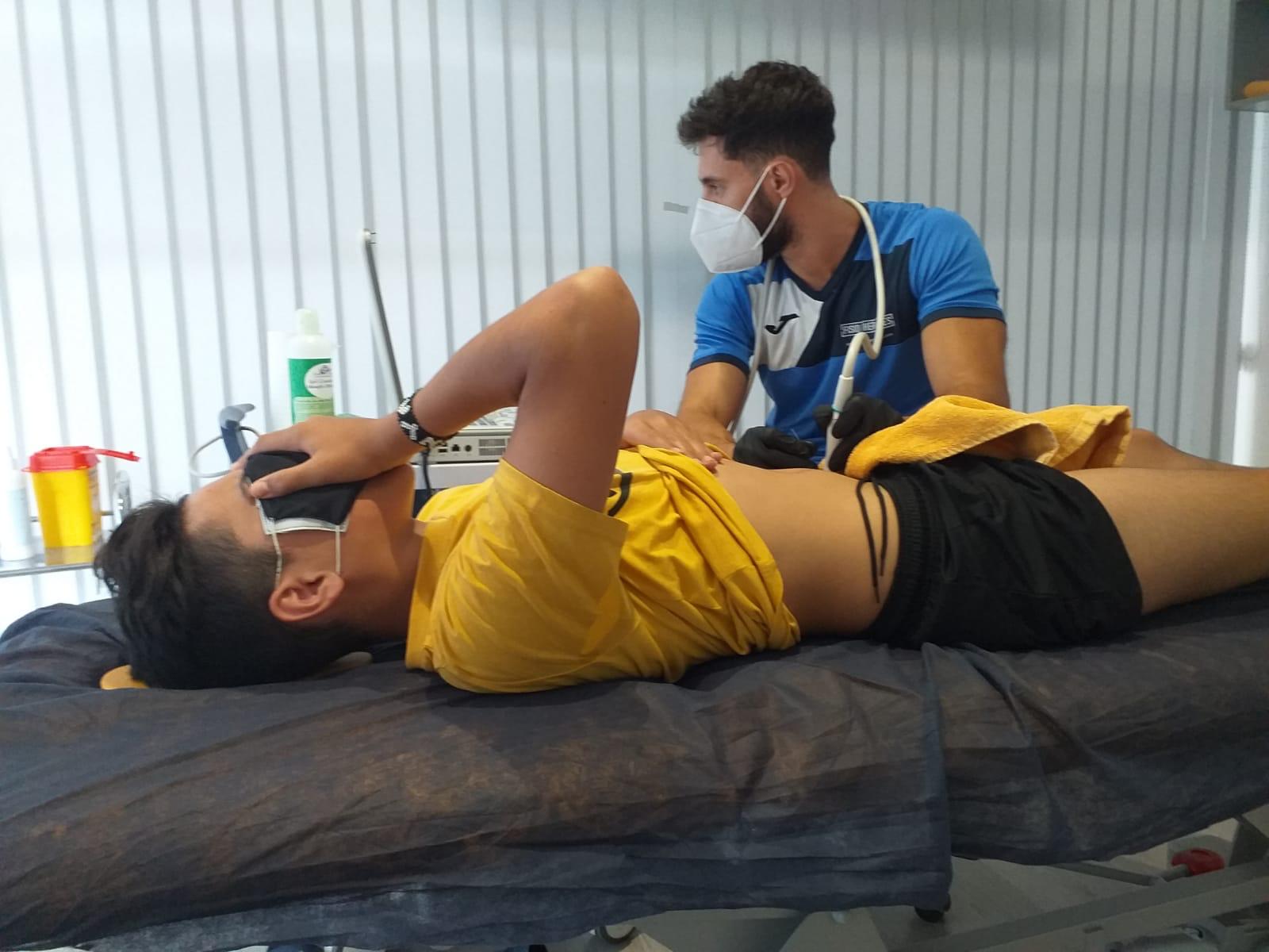 Football academy player receiving treatment during injury rehabilitation, highlighting the physical and mental toll of setbacks.