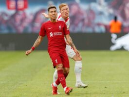 Roberto Firmino applying defensive pressure during open play, illustrating the modern defensive striker role.