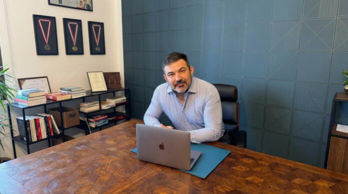 Hunor Dudás in his office discussing football leadership and management strategy.