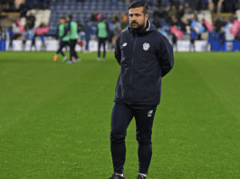 Nadir Sönmez, UEFA A Licensed football coach, standing on the pitch during a matchday warm-up at a professional stadium.