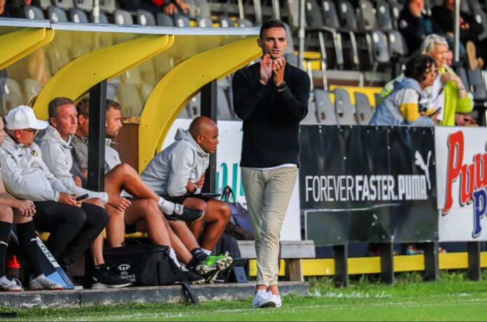 Omar Adlani directing his team from the touchline during a competitive league match.